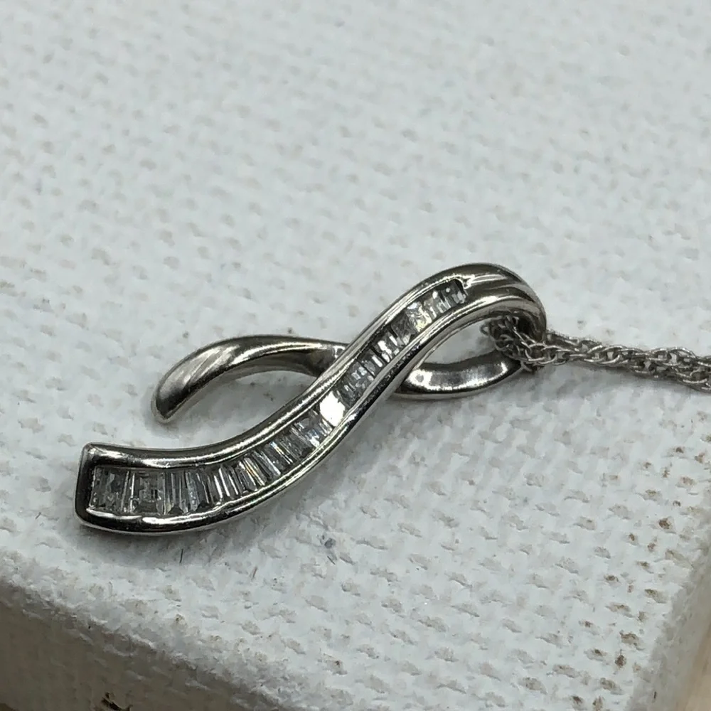 Solid 10k white gold multi baguette diamond wishbone pendant necklace.
